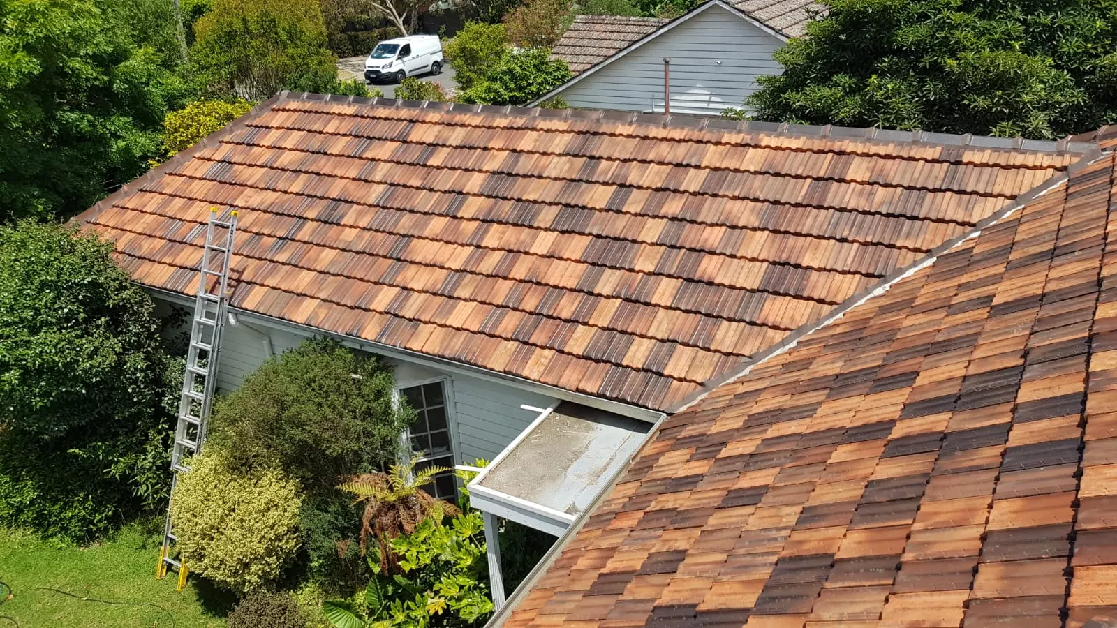 Wide view of terracotta tiled roofs during restoration work